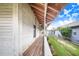 Long covered porch with wooden flooring and access to backyard at 29 Turtle Ln, Haines City, FL 33844