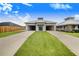 House exterior with double driveway and manicured lawn at 29 Turtle Ln, Haines City, FL 33844