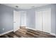 Bedroom with double door closet and wood-look floors at 9260 Winchester Estates Blvd, Lakeland, FL 33810