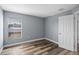 Light grey bedroom with wood-look floors and window at 9260 Winchester Estates Blvd, Lakeland, FL 33810