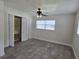 Bedroom with ceiling fan, tile floor, and built-in closet at 508 N Oak Ave, Fort Meade, FL 33841