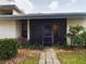 Condo entrance with screened porch and landscaping at 2049 San Marcos Se Dr # 127, Winter Haven, FL 33880