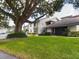 Exterior of building with landscaping and large tree at 2049 San Marcos Se Dr # 127, Winter Haven, FL 33880