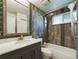 Updated bathroom with gray tile and a large mirror at 2049 San Marcos Se Dr # 127, Winter Haven, FL 33880