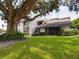 Building exterior nestled under a large shade tree at 2049 San Marcos Se Dr # 127, Winter Haven, FL 33880