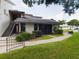 Ground level condo entrance with stairs and landscaping at 2049 San Marcos Se Dr # 127, Winter Haven, FL 33880