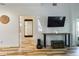 Modern living room with wood-look tile floors and large TV at 2049 San Marcos Se Dr # 127, Winter Haven, FL 33880