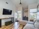 Bright living room with vaulted ceiling, sofa, and large TV at 2049 San Marcos Se Dr # 127, Winter Haven, FL 33880
