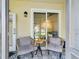Cozy screened patio featuring wicker chairs and a small table at 2049 San Marcos Se Dr # 127, Winter Haven, FL 33880