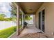 Covered patio with screened enclosure, outdoor grill, and wooden table at 3540 Julius Estates Blvd, Winter Haven, FL 33881