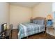 Bedroom with striped bedding and wood floors at 3540 Julius Estates Blvd, Winter Haven, FL 33881