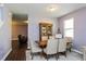 Bright dining room featuring a wood table and chairs, hardwood floors, and access to the kitchen at 3540 Julius Estates Blvd, Winter Haven, FL 33881