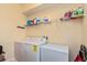 Bright laundry room, washer, dryer, and ample shelving for storage at 3540 Julius Estates Blvd, Winter Haven, FL 33881