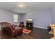 Living room features dark hardwood floors, a brown leather couch, and a large TV at 3540 Julius Estates Blvd, Winter Haven, FL 33881