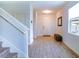 Bright and airy entryway with tile flooring, staircase, and storage bench at 1011 Overlook Ct, Davenport, FL 33837