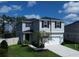 Two-story house with gray siding, white garage door and a fenced yard at 1011 Overlook Ct, Davenport, FL 33837