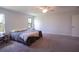 Main bedroom with king bed, two windows, and carpet flooring at 1011 Overlook Ct, Davenport, FL 33837