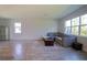 Living room features a sectional sofa, coffee table, and large windows at 1011 Overlook Ct, Davenport, FL 33837