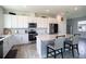 Modern kitchen with white cabinets, stainless steel appliances, and an island at 1011 Overlook Ct, Davenport, FL 33837