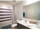 Bathroom with double vanity, shower/tub combo, and toilet at 1011 Overlook Ct, Davenport, FL 33837