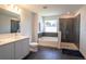 Bathroom features a soaking tub, walk-in shower, and double vanity at 1011 Overlook Ct, Davenport, FL 33837