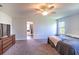 Main bedroom with large bed, ceiling fan, and en-suite bathroom access at 1011 Overlook Ct, Davenport, FL 33837