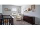 Bedroom featuring a crib, armchair, dresser, and plenty of natural light at 1011 Overlook Ct, Davenport, FL 33837