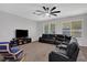 Relaxing Gathering room with sectional sofa, ceiling fan, and large TV at 2433 Home Again Rd, Apopka, FL 32712