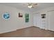 Spacious bedroom with wood-look floors, large windows and double closets at 2433 Home Again Rd, Apopka, FL 32712