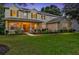 Two-story house with landscaped yard, lit at dusk at 2433 Home Again Rd, Apopka, FL 32712