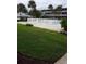 Community pool with grassy area and palm trees at 1700 6Th Nw St # C7, Winter Haven, FL 33881