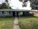 Ranch-style home with gray exterior and a well-maintained lawn at 100 Stevenson Rd, Winter Haven, FL 33884