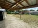 Backyard with covered patio and partially fenced yard at 100 Stevenson Rd, Winter Haven, FL 33884