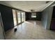 Living area with tile flooring and access to the backyard at 100 Stevenson Rd, Winter Haven, FL 33884