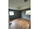 Bedroom with wood-look floors and two windows at 100 Stevenson Rd, Winter Haven, FL 33884