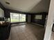 Living room with tile floors and a large window at 100 Stevenson Rd, Winter Haven, FL 33884