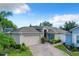 Exterior view of a charming house with a brick driveway and landscaped front yard at 3337 Raleigh Dr, Winter Haven, FL 33884