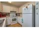 White kitchen with updated appliances and a charming coastal feel at 4234 Cerimen St, Lake Wales, FL 33898
