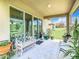 Relaxing back patio with seating, plants, and backyard view at 278 Alford Dr, Davenport, FL 33896