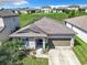 One-story house with a brown roof and attached garage at 278 Alford Dr, Davenport, FL 33896