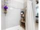 Clean bathroom with shower stall, tile surround, and wooden shelf at 278 Alford Dr, Davenport, FL 33896