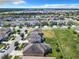 Aerial view of a residential neighborhood featuring houses and solar panels at 278 Alford Dr, Davenport, FL 33896