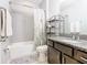 Bathroom with tub, shower, granite vanity, and floral shower curtain at 278 Alford Dr, Davenport, FL 33896