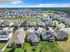 Aerial view showcasing a residential area with many houses and solar panels at 278 Alford Dr, Davenport, FL 33896