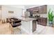 Modern kitchen with dark cabinetry, granite countertops and island at 278 Alford Dr, Davenport, FL 33896