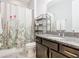 Bathroom with tub, shower, granite vanity, and floral shower curtain at 278 Alford Dr, Davenport, FL 33896