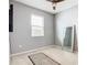 Bright bedroom with window, mirror, and area rug at 278 Alford Dr, Davenport, FL 33896