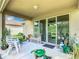 Covered patio with seating and sliding glass doors at 278 Alford Dr, Davenport, FL 33896