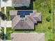 Aerial view of house with solar panels and a well-maintained lawn at 278 Alford Dr, Davenport, FL 33896