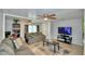 Living room with gray couch, coffee table, and large TV at 4590 San Heath Rd, Bartow, FL 33830